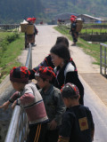 children from the Red Dao tribe throwing stones into a river