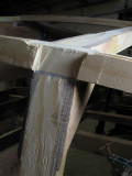 Fairing: excess wood over a frame is filed away to establish the correct bevel. The logs and the keelson are planed fair.