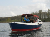 Second mate enjoys the view from  the engine box.  First time Ive seen the big boat from the water, with the boot stripe on.