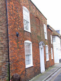 Townhouse with bricked-up window.