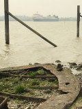 Sunken barge beside the shore.