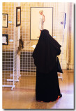 April 10: A Muslim woman checks out the art exhibit at Portland City Hall. (Culture, garb, dress)