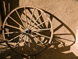 In the small courtyard -- wagon wheel in sunlight