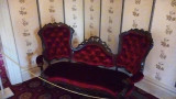 This curved red velvet couch was acquired by Sarah when she was in the White House, although it was not used there.