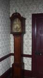 A grandfather clock in the front hallway of the house.