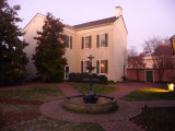 A rear view of the house with the fountain in the foreground.
