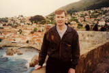 Me posing along Dubrovniks defensive wall with waves of the Adriatic Sea breaking below.