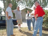 WHILE RANDY HOLDS UP THE TREE OTHERS LISTEN