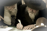 Rabbi Marcus completing the last letter with Rabbi Newman looking on