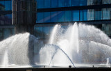 Whitish water in front of glass building