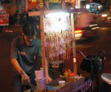 Street vendor with roasted squids, Saigon