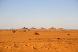 Six small hills rising out of an otherwise flat desert