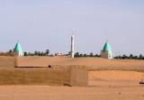 Minaret with a pair of elaborate green-domed tombs near Abu Dom