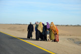 A group of women walking along the road