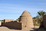 Mud brick wall and round building