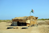 Primitive dwelling flying a tattered Sudanese flag