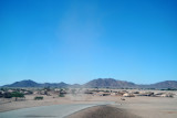 Dust devil swirling by a village