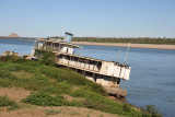A smaller river boat, the Kirbeka, listing in the water at Karima