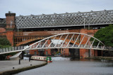 The new pedestrian bridge over the Bridgewater Canal with the Castlefield railway viaducts