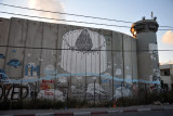 West Bank Separation Wall graffiti - Christmas tree encircled by the Wall with tree stumps, Bethlehem