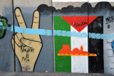 West Bank Separation Wall graffiti - Peace symbol with Palestinian flag