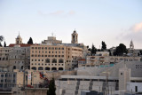 Church of the Nativity behind some modern buildings