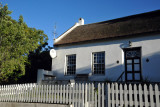 An old thatched cottage with a white picket fence...and satellite dish, Swellendam