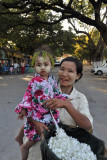 Flower peddler and girl with traditional painted face
