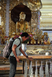 Dennis handing over his flowers to Buddha