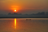 Sunrise with a small boat on the Irrawaddy River, Sagaing