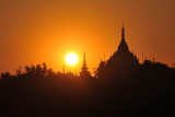 Sunrise with the stupas of the temple by the Sagaing Bridge
