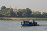 A boat sails upstream past a left-bank temple opposite Ywathigyi