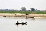 Fishermen and a small hut on the riverside floodplain