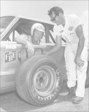 Driver Jim Paschal checks out his tire