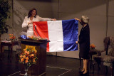 Christine Lagarde presenting a French flag to a member of the Board of Trustees