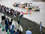 Colored lanterns floating to shore