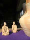 Clay figures on a pottery shop windowsill