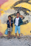 posing in front of the graffiti covered wall