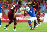 Abdul Razak (12) and Gary Steven Robbat (15) tussles for the ball 