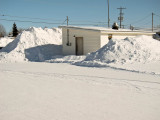 2011 March 7 snow piled at chip stand on First Street