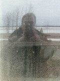 Paul reflected in (his own) dirty office window, the Moose River in background 2011 April 26