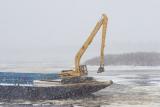 Barge carries excavator to help with ice