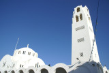 The ornate bell tower and the majestic Metropole Greek Orthodox Church in Fira.