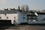 Smoke issues from the distillery turrets as the malted barley is gets its distinctive peat smoked flavour