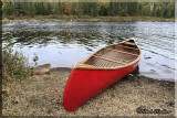 Red Canoe On The Shore Of Costello Lake      