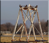 A Male Type Snowy Owl Sitting Atop An Airport Metal Structure In Field