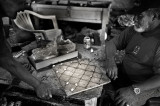 A game of checkers as played on the island. Shells and cigarette butts for markers. L1020821.jpg