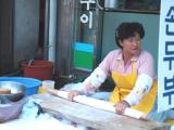 Ajuma preparing the dough for making Kalguksu( flat noodles)