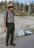 A Yellowstone National Park Ranger provides information in front of Grand Geyser
