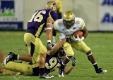 Jackets A-back Tony Zenon runs out of the tackle of Catamounts DL Trey Shelby